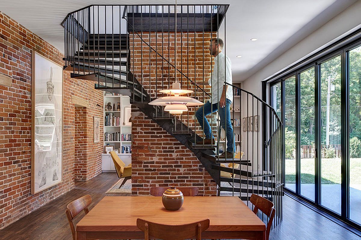 5b6152bbcc430Metallic-spiral-staircase-and-exposed-brick-walls-steal-the-show-on-the-lower-level-living-room