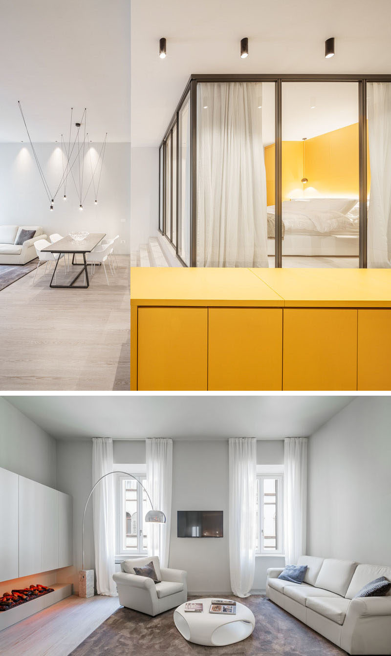 Small Apartment Ideas - This small apartment has a hidden kitchen within a yellow sideboard, a glass enclosed bedroom, and storage hidden under the stairs.